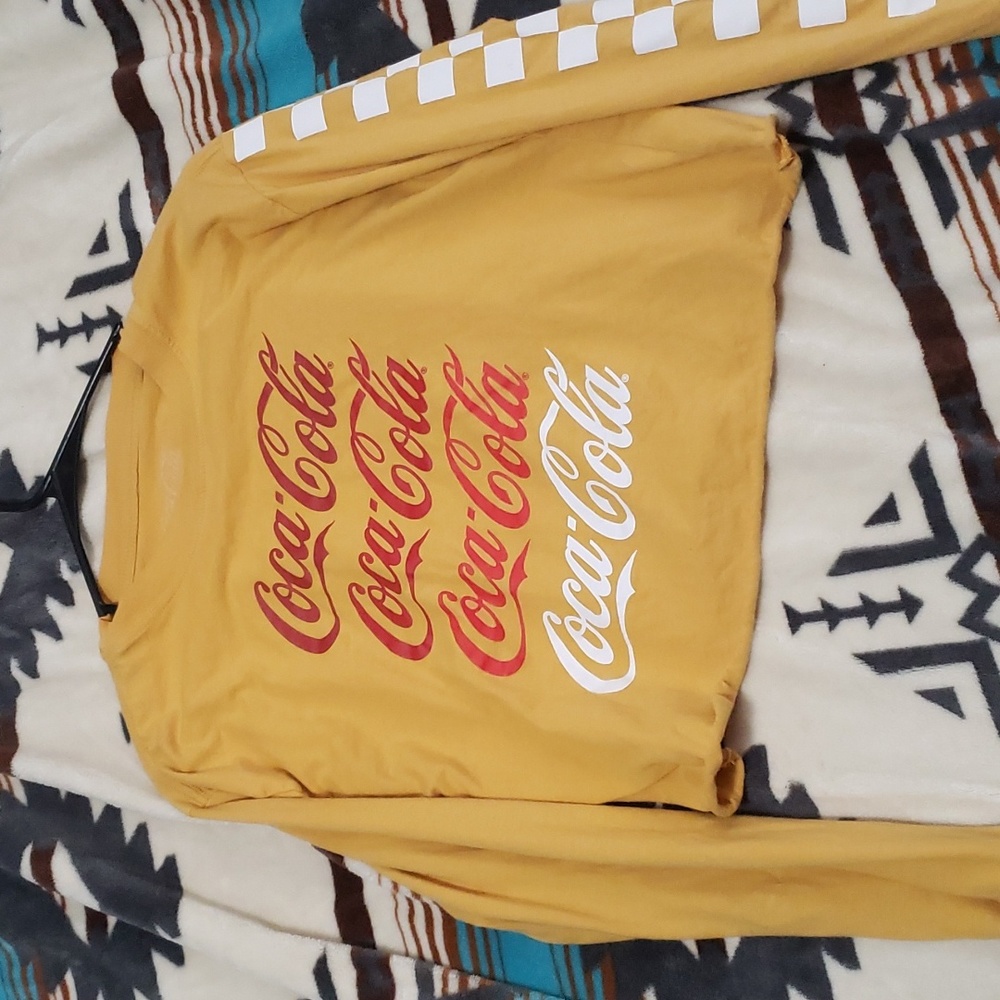 Cute coke crop top. It is a small and has checkered pattern on one sleeve.
